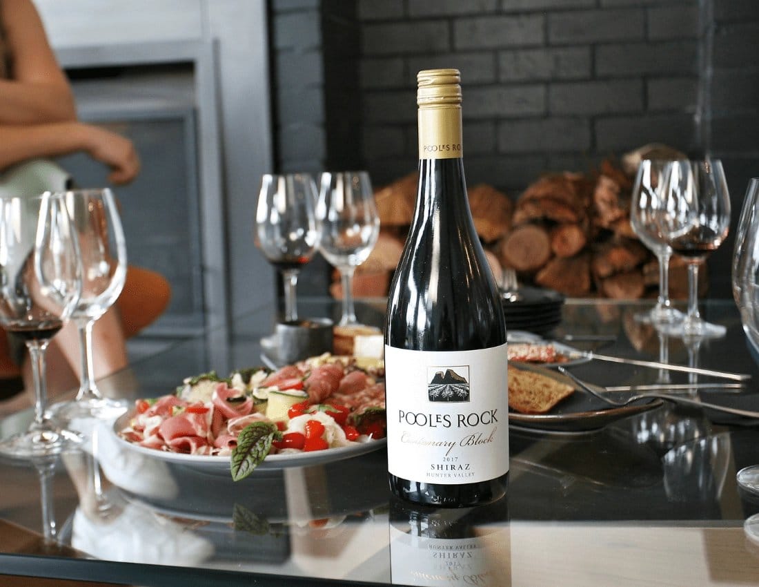 Pooles Rock wine with glasses and charcuterie spread