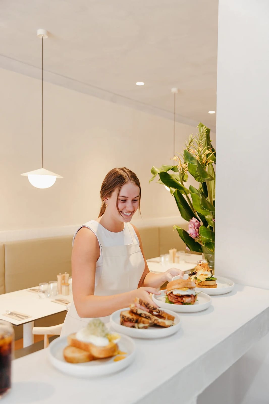 Modern dining interior with plated dishes and fresh flowers at Ronnies, Pokolbin, Hunter Valley