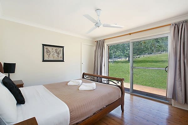 Bedroom interior with queen bed and garden terrace