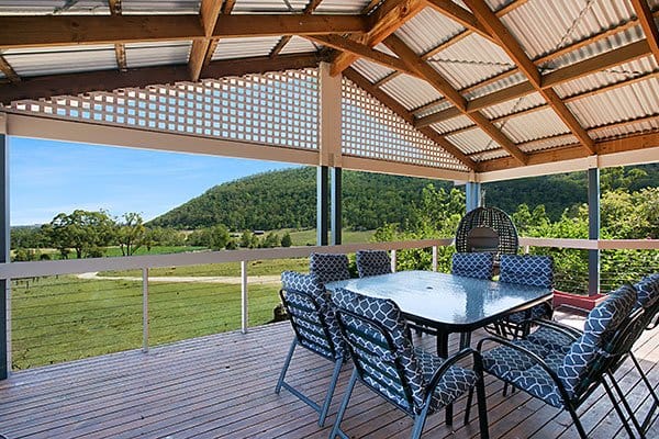 Outdoor deck overlooking vineyard and mountain landscape