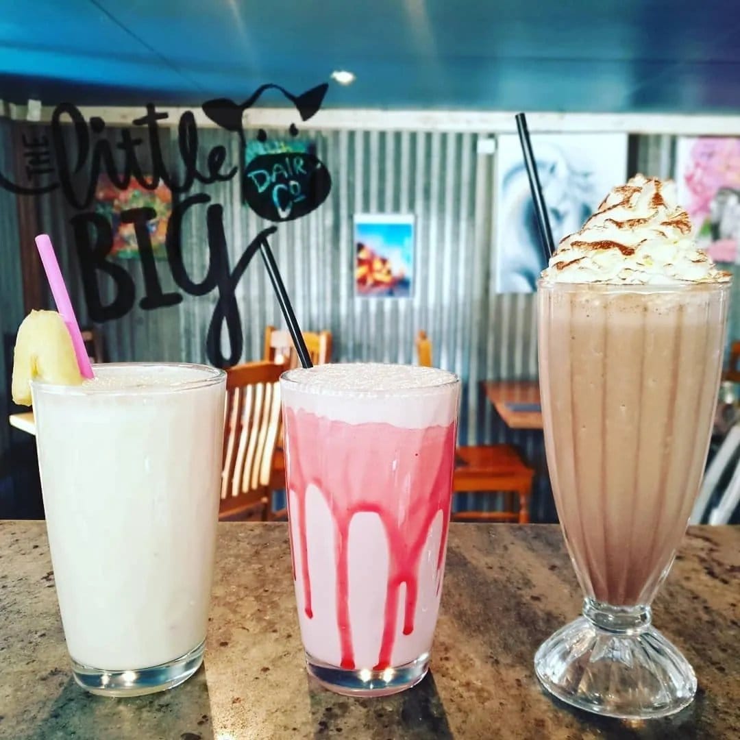Milkshakes on the counter at Simply DVine Cafe, with The Little Big Dairy Co signage