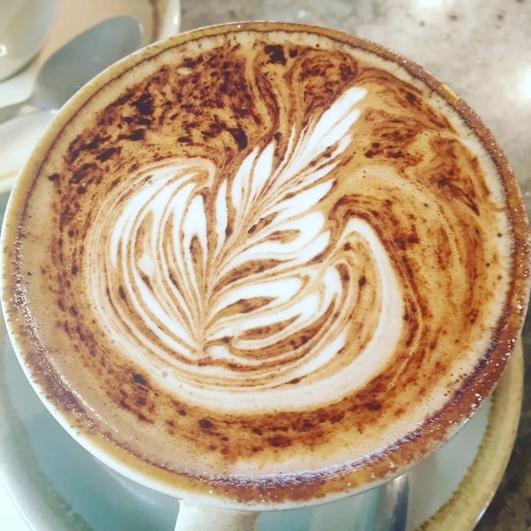 Latte art in a cup at Simply DVine Cafe