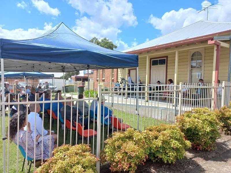 Outdoor event venue with blue tent canopy and brick building at Sir Edgeworth David Memorial Museum, Hunter Valley