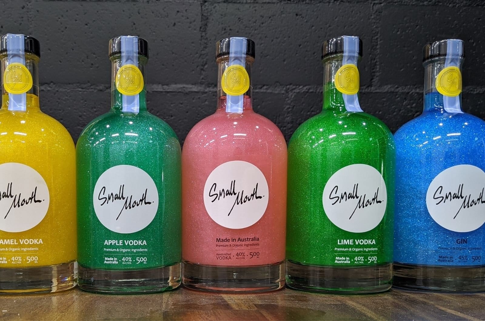 Bottles of Small Mouth vodka and gin in yellow, green, pink and blue at Pokolbin, Hunter Valley