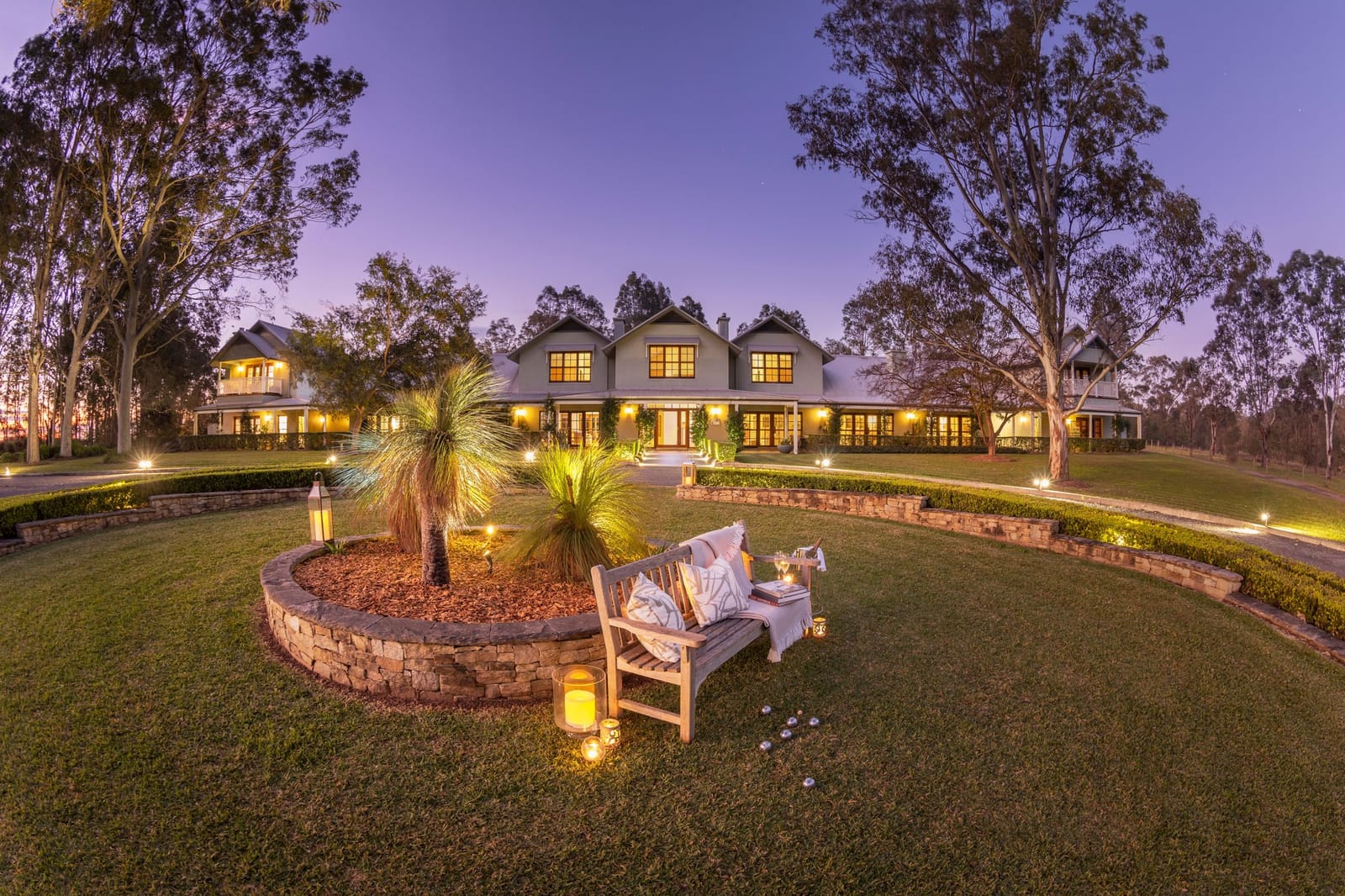 Manor house exterior lit at night with grounds