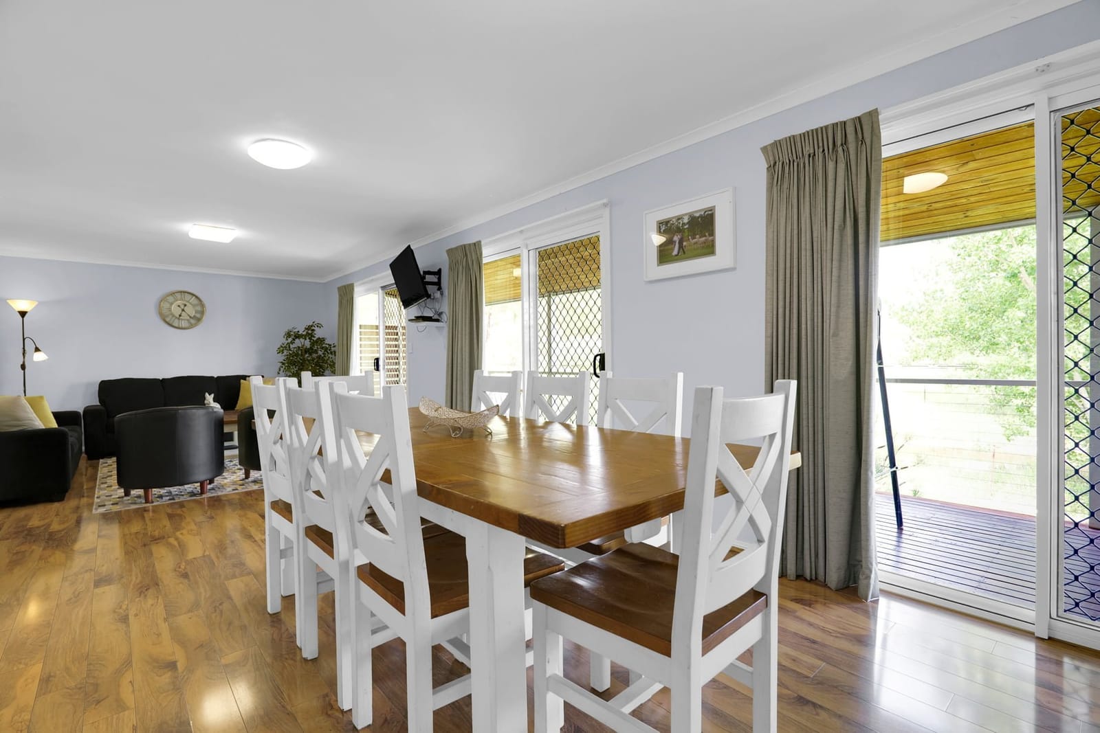 An open-plan cottage lounge and dining room with a long timber table