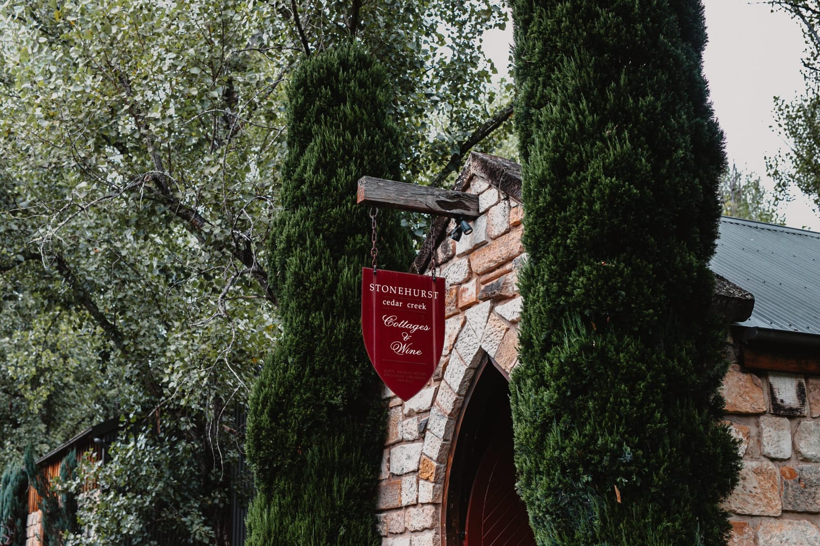Stone building entrance with ivy and red wine sign at Stonehurst, Wollombi, Hunter Valley