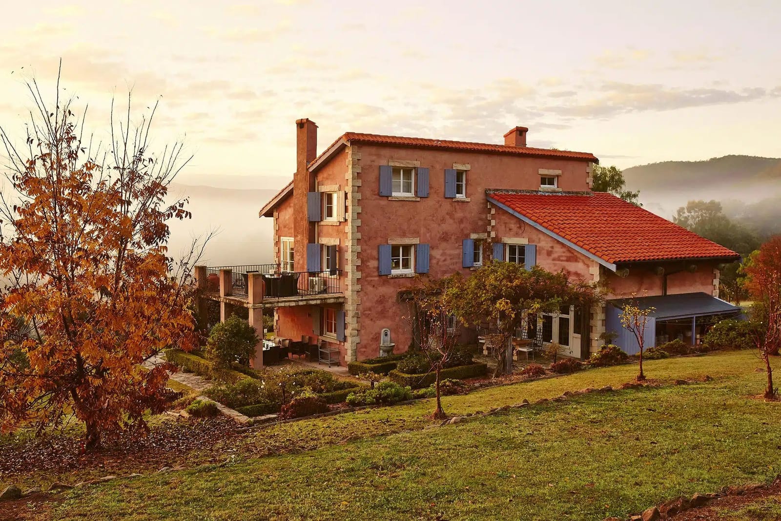 Red terracotta Italian-style villa on grounds with landscaping at Talits, Broke Fordwich, Hunter Valley