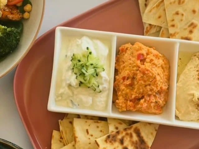 Plated Indian food with rice and spiced accompaniments on plate