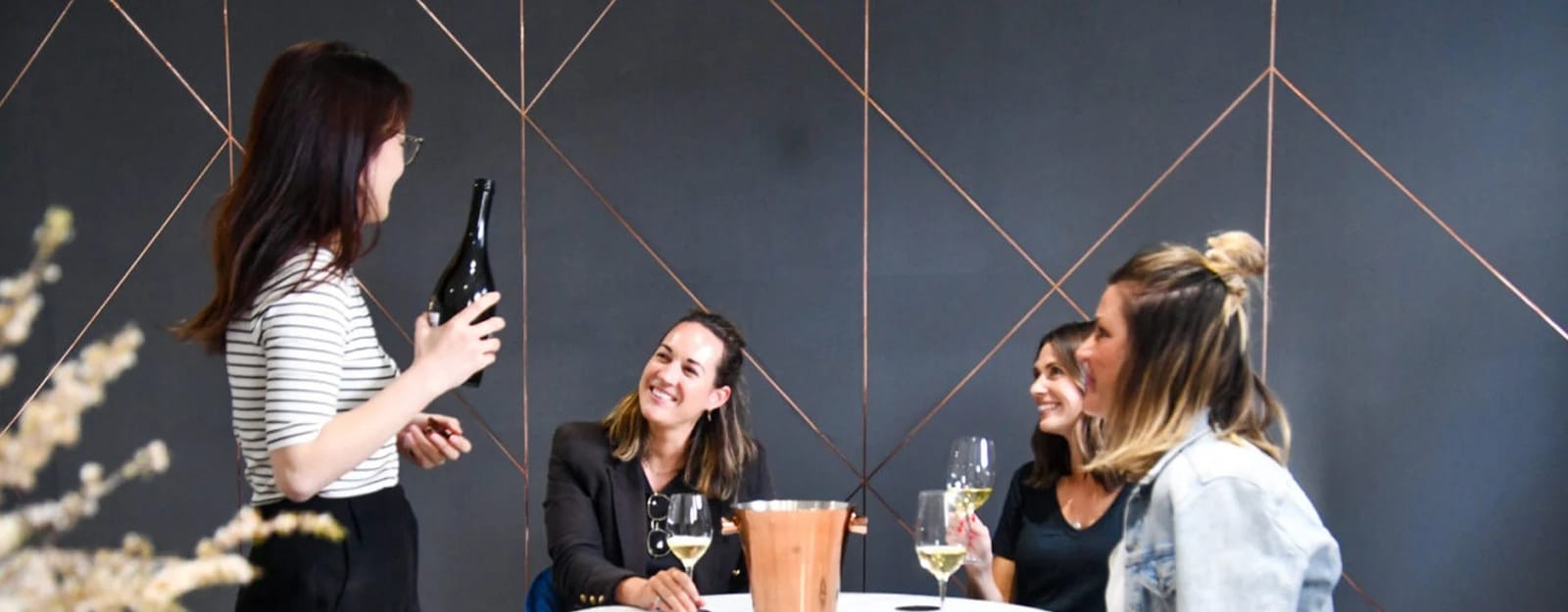 Cellar door wine tasting with guests enjoying wine in modern interior at Tempus Two Gin, Pokolbin, Hunter Valley