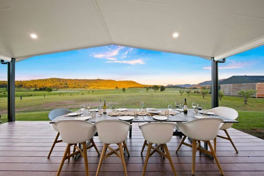 Outdoor pavilion with long table set for dinner service