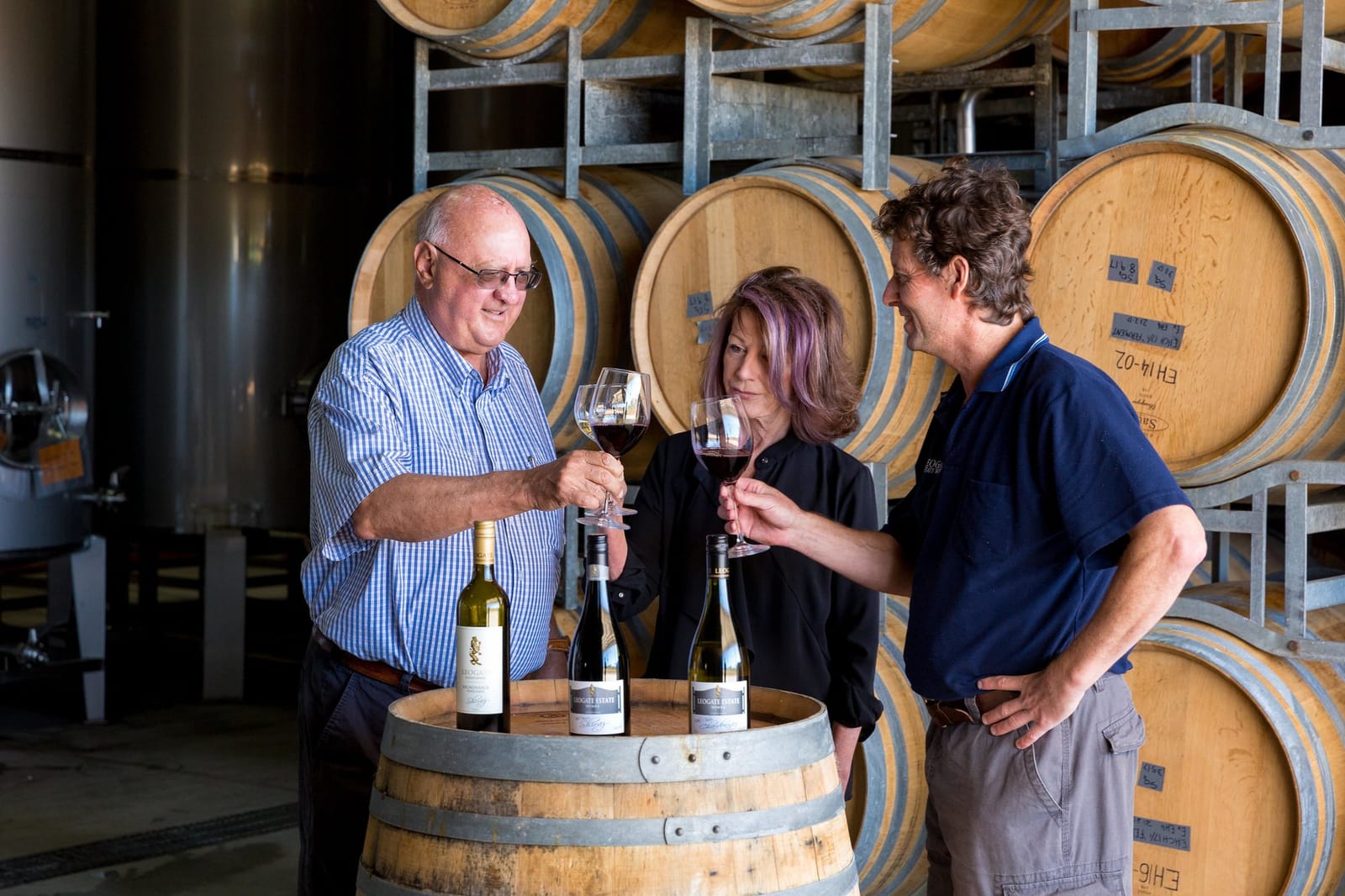 The Leogate Estate team sharing a toast in the barrel hall