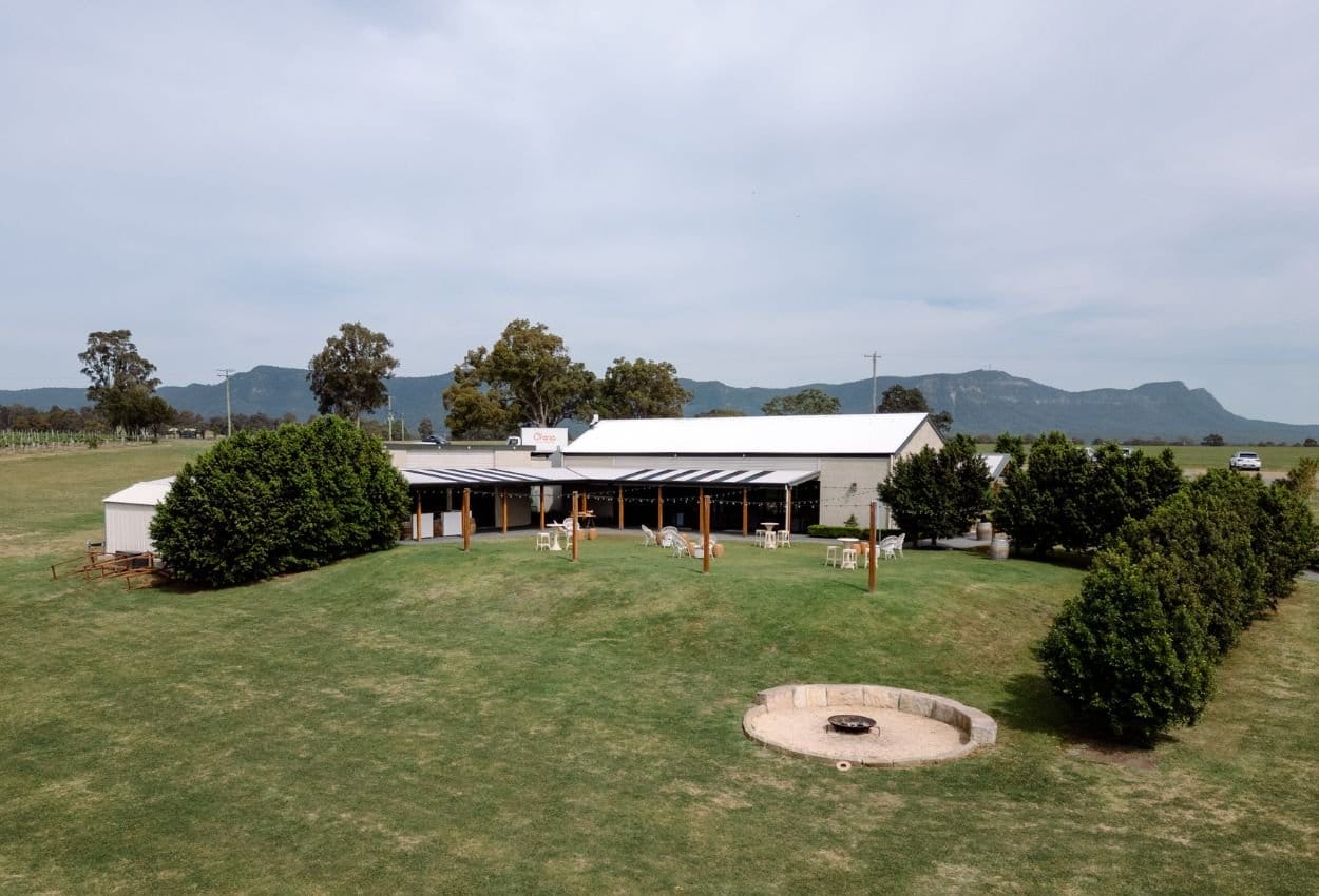 Aerial view of The Lane Retreat's homestead building and lawns on Palmers Lane, Pokolbin