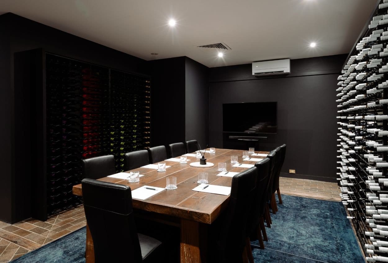 Private dining room lined with wine racks at The Lane Retreat