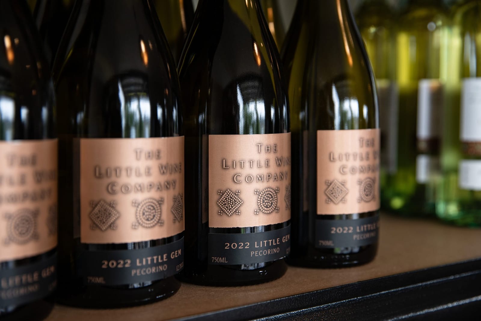 The Little Wine Company bottles with wine glasses and charcuterie