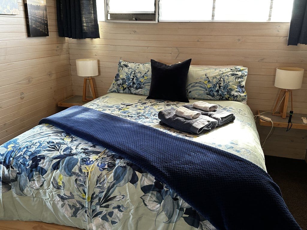 Bed with patterned bedding in guest bedroom