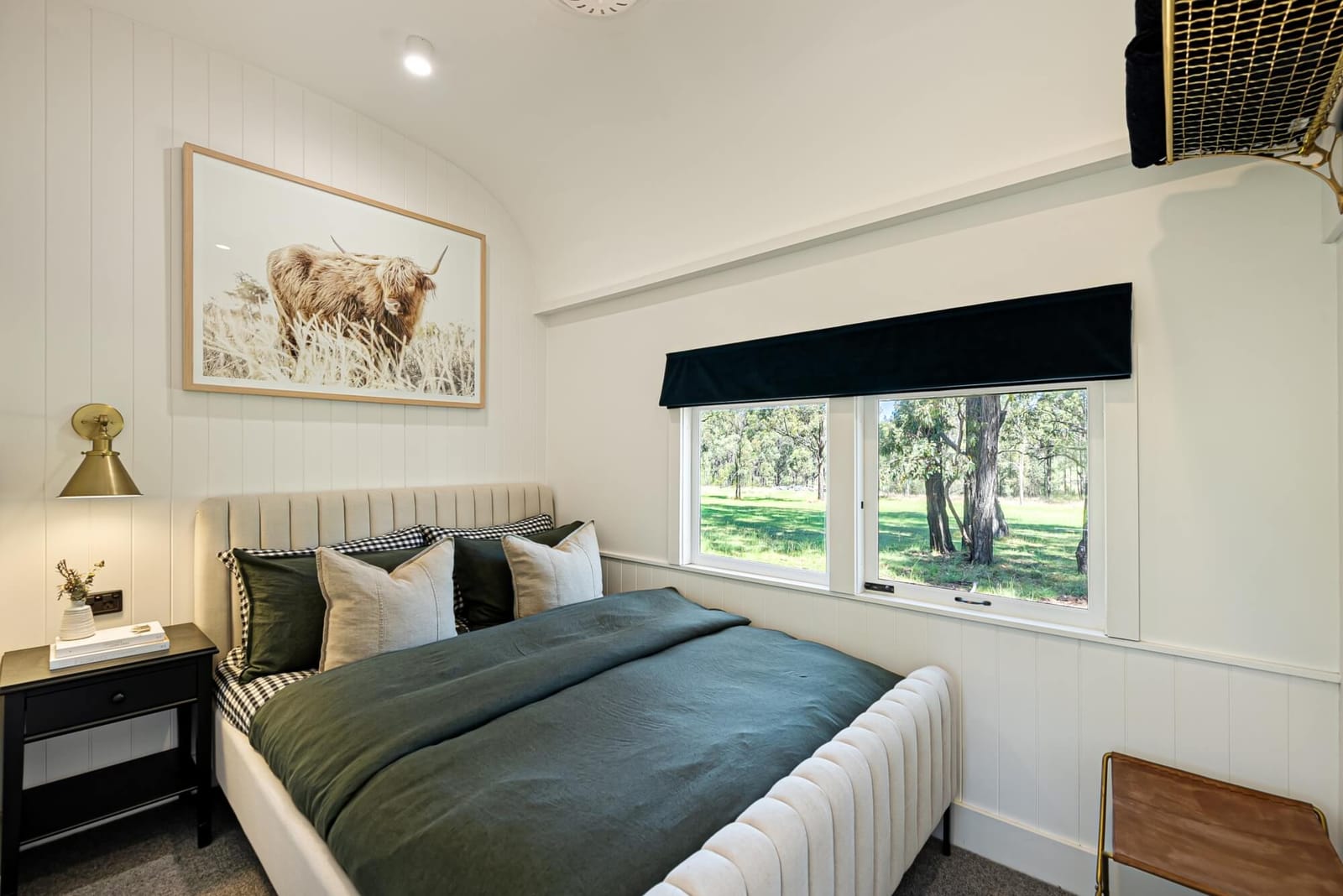 Bedroom with countryside views inside a restored carriage