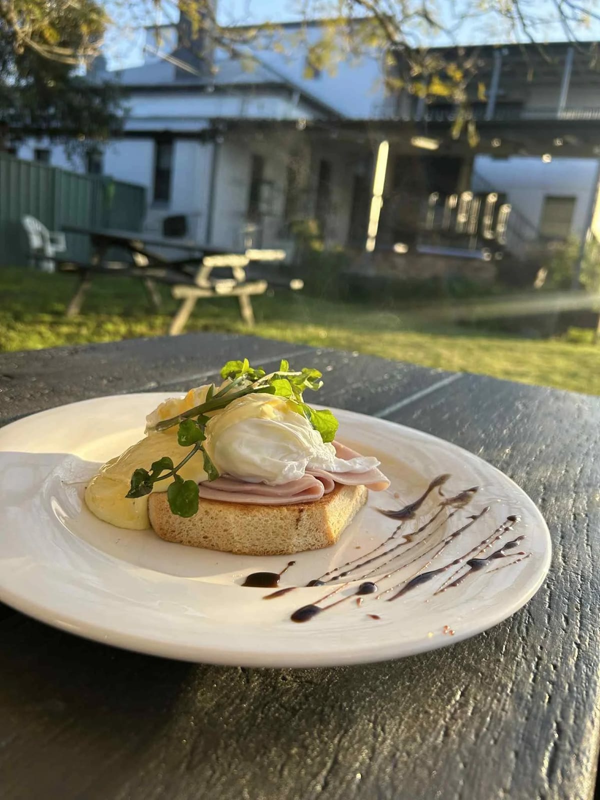 Plated eggs Benedict on white serviette at The Thirsty Horse, Greta, Hunter Valley