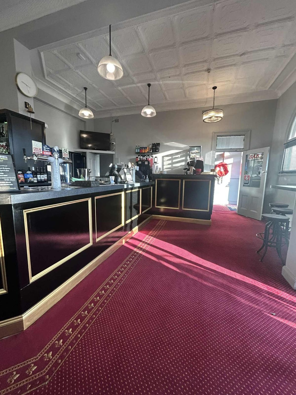 Bar counter with dark finishes and pendant lighting