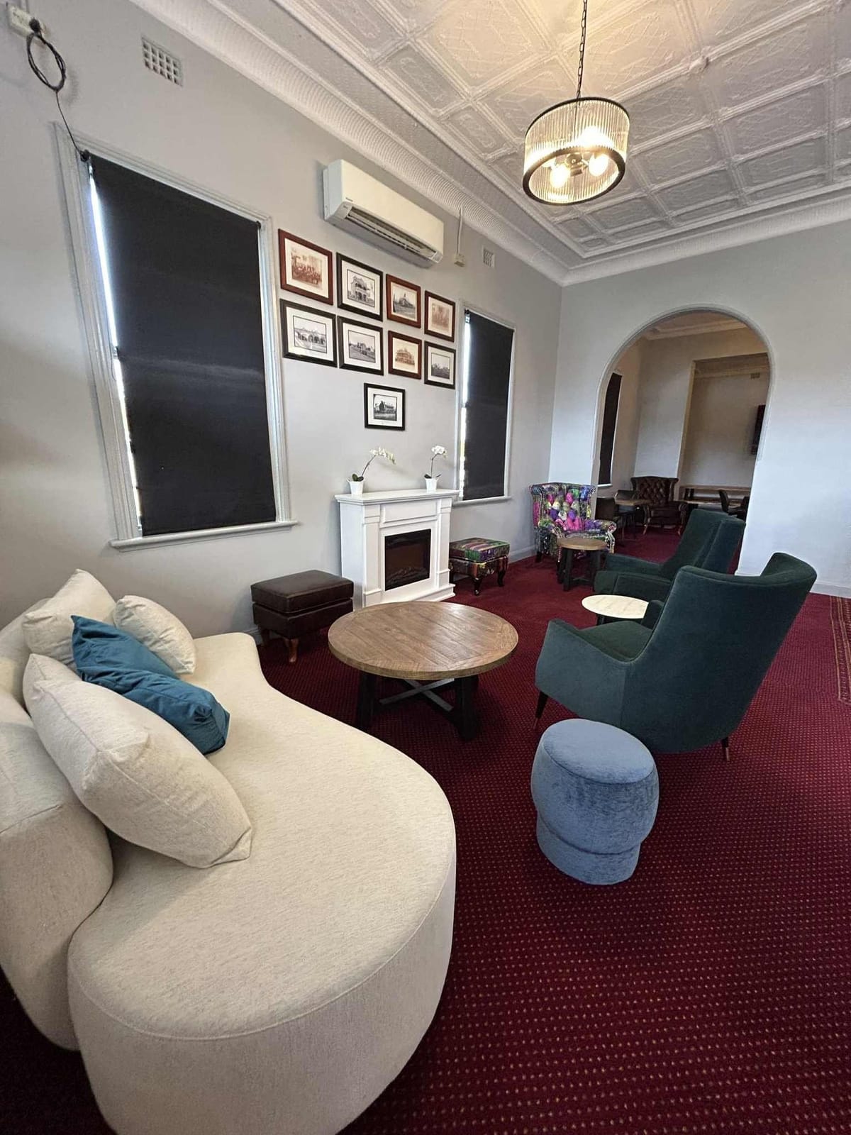 Cream upholstered lounge in sitting room with fireplace
