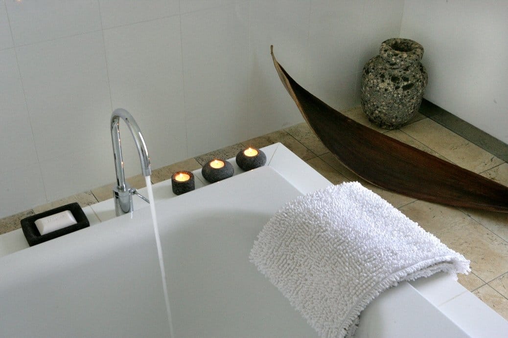 A deep ensuite bath with tea lights along the rim