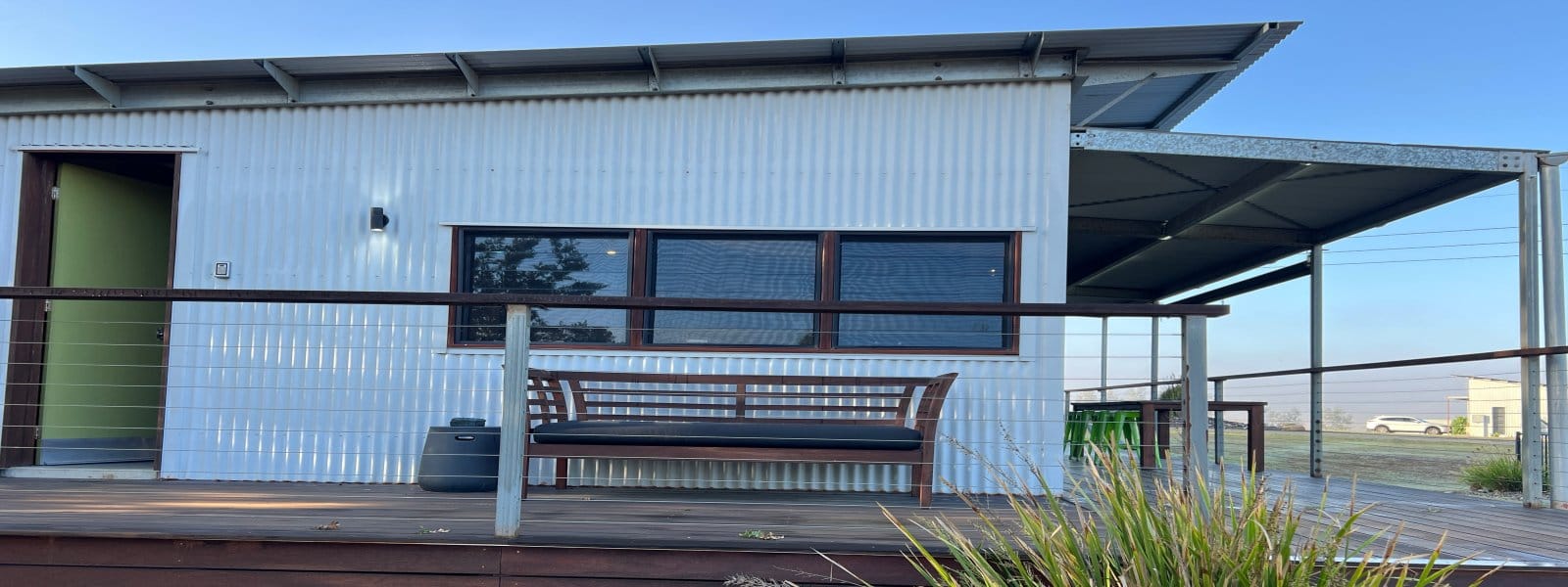 The corrugated iron facade and timber deck outside a suite