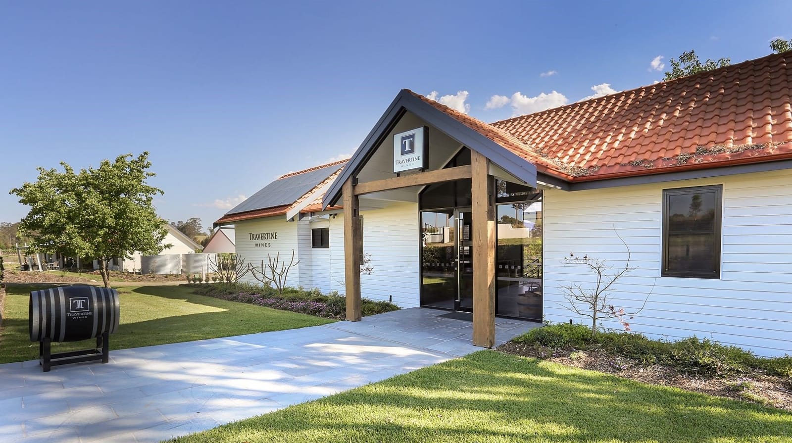 Modern white cellar door building with red tile roof at Travertine, Belford, Hunter Valley