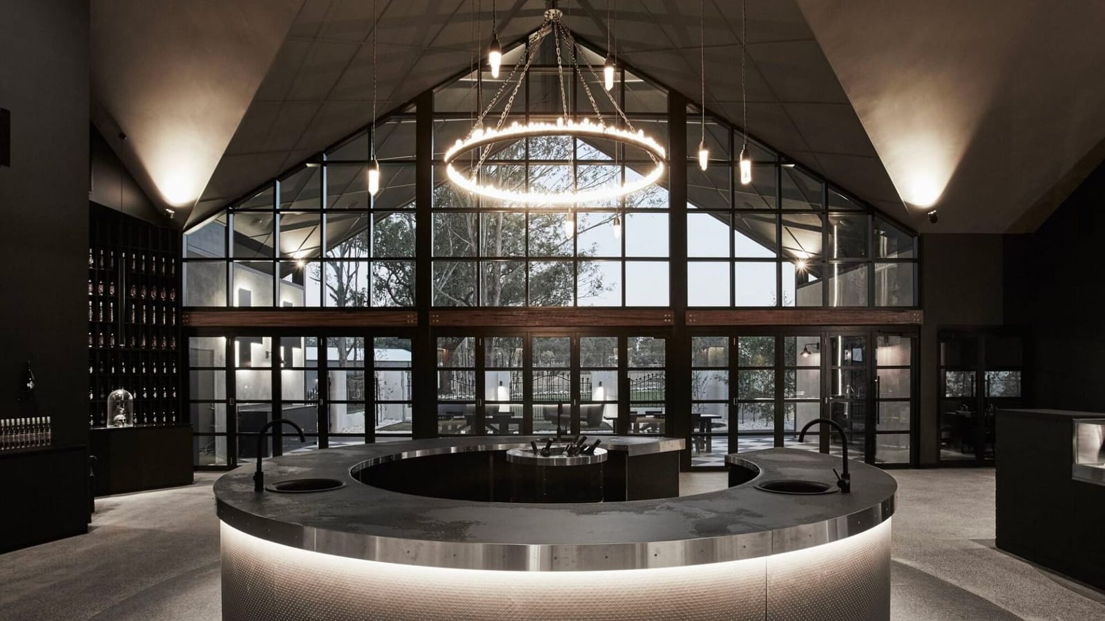 Modern tasting room interior with dramatic lighting and vineyard views at Vamp, Hunter Valley