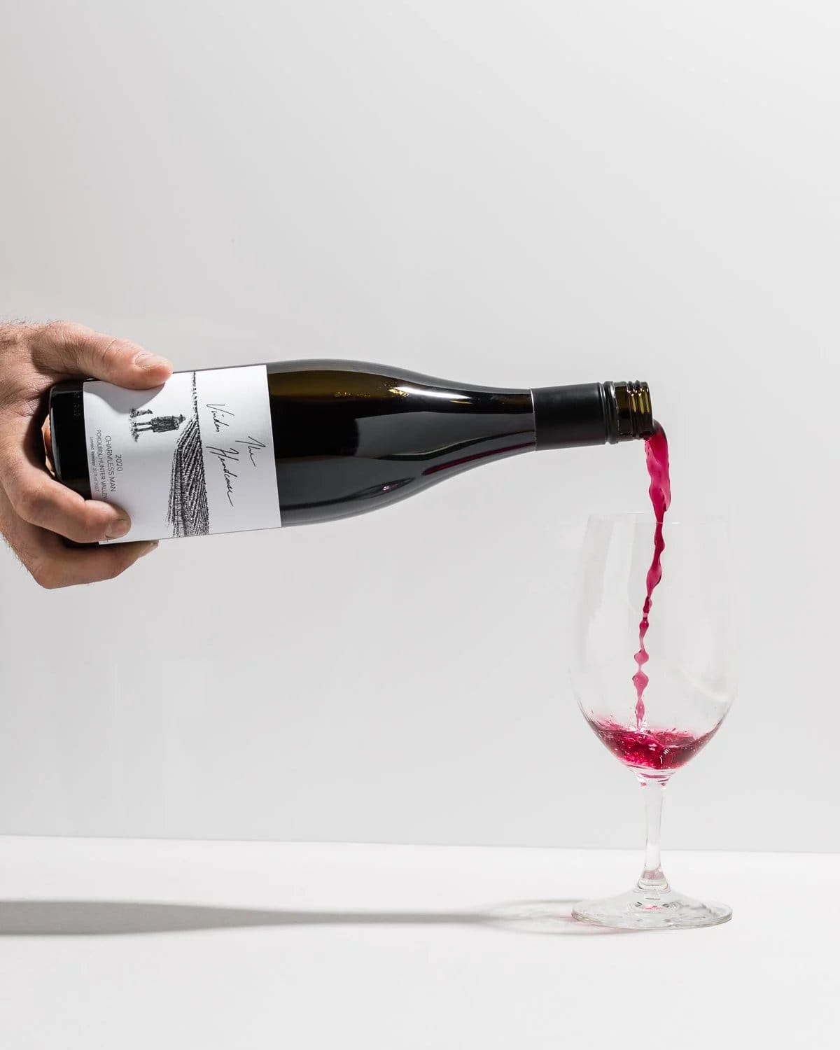 White wine flowing into clear glass