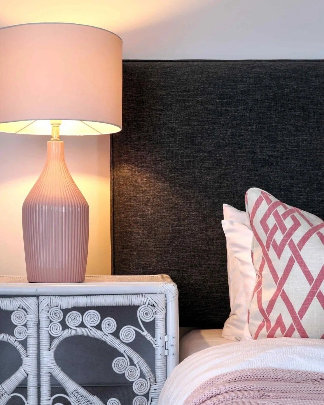 A bedroom at Willow Tree Estate with a pink lamp and patterned cushions