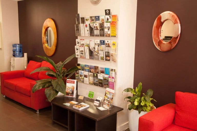 Lobby entrance with red seating and information display wall