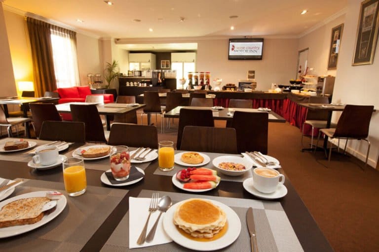 Breakfast buffet with fresh fruit, pastries and beverages