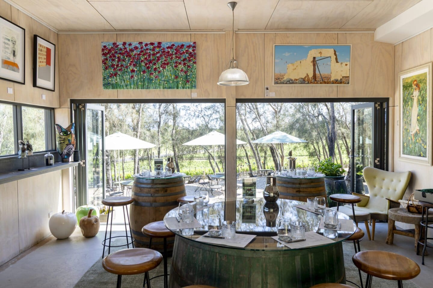 Tasting room with timber interior, barrel tables and vineyard outlook