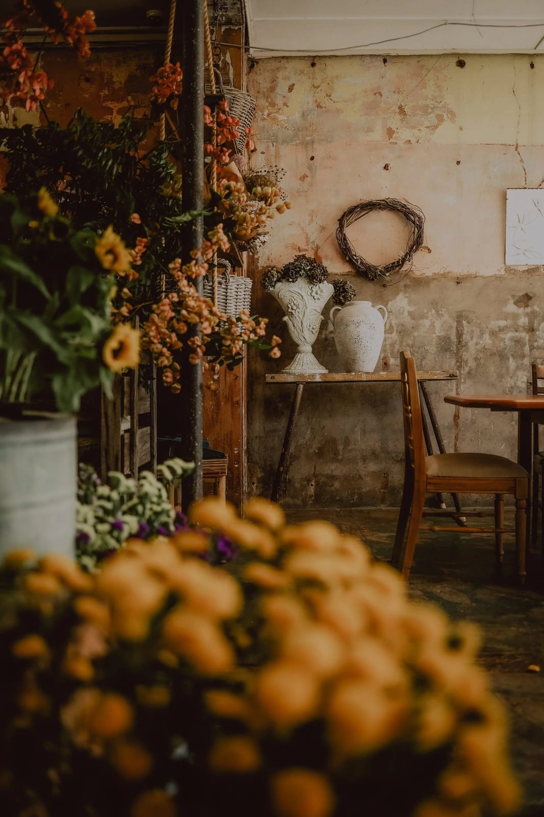 Hands binding a wreath at a floral workshop